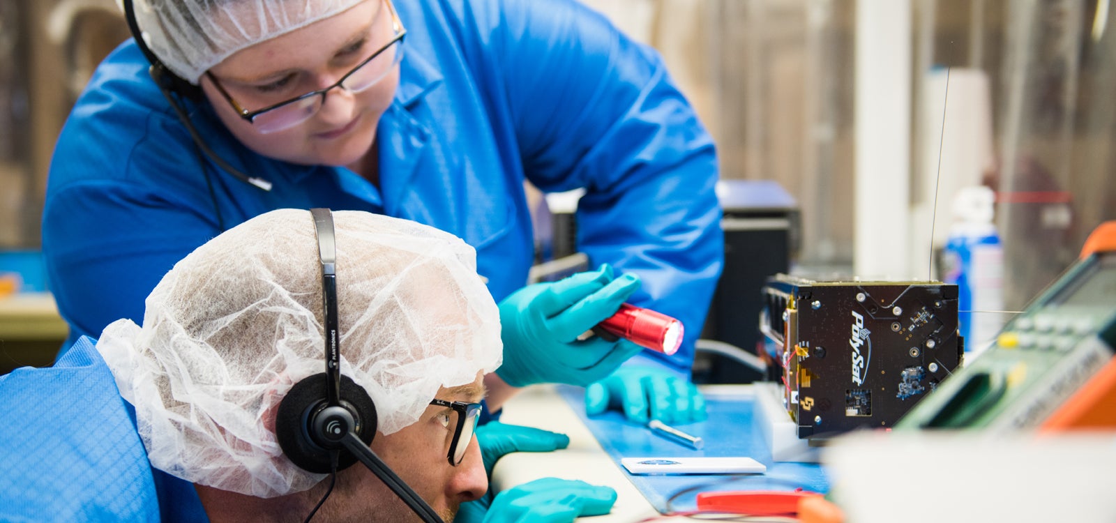 Cal Poly engineering students work on a cubesat