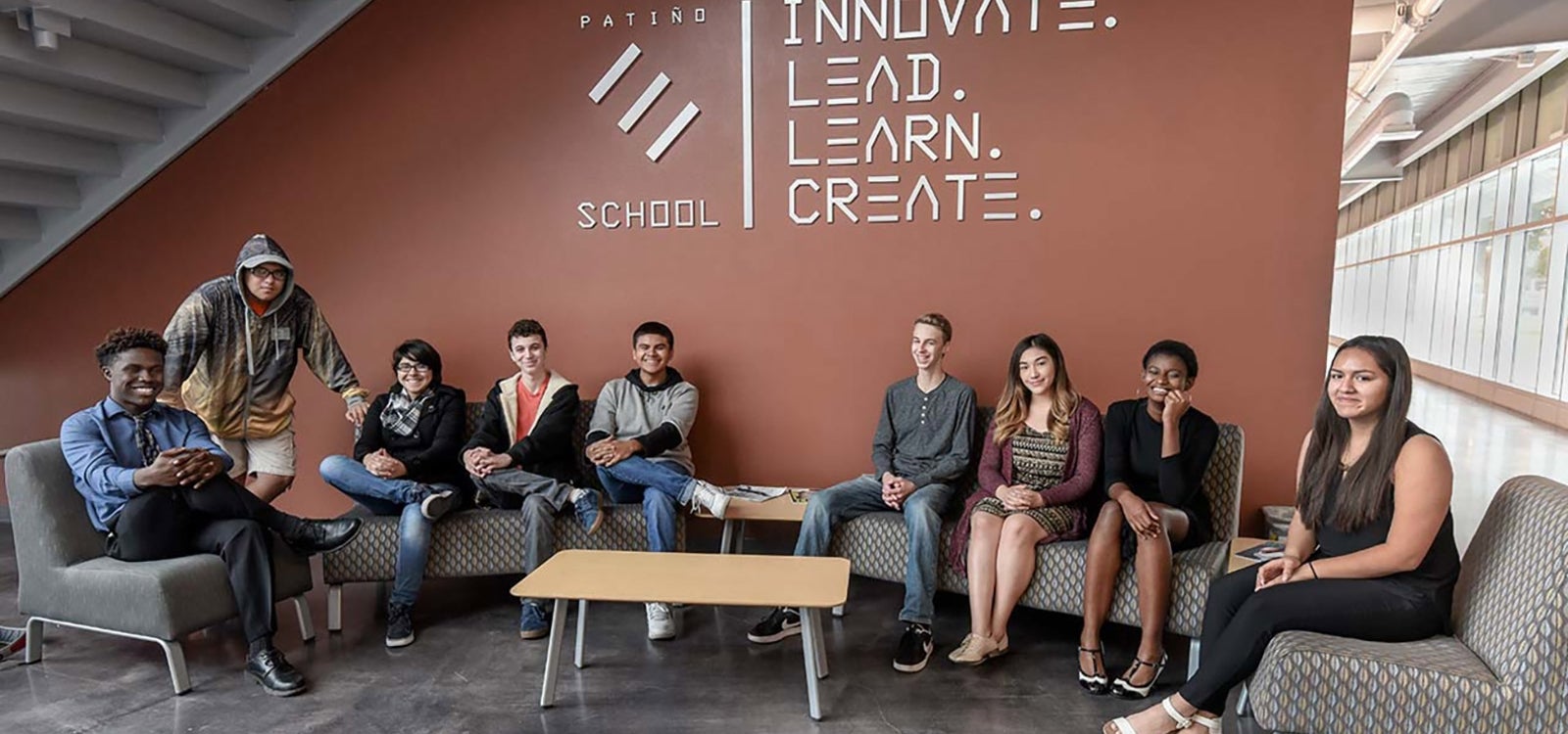 Students of the Patino School pose in front of their school's sign