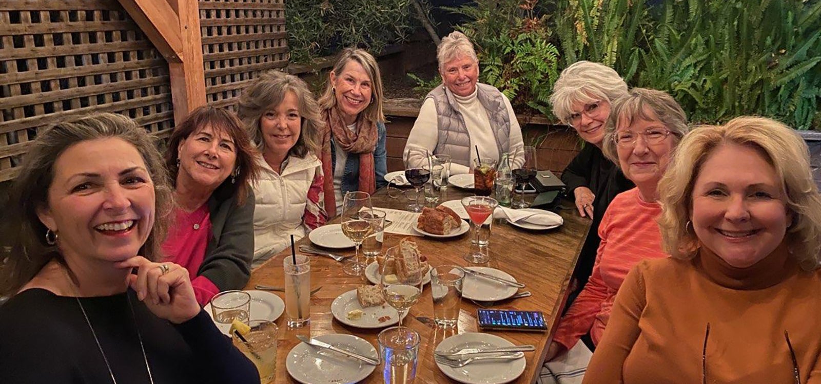 Group photo of former members of Cal Poly Journalism Advisory Board at a restaurant