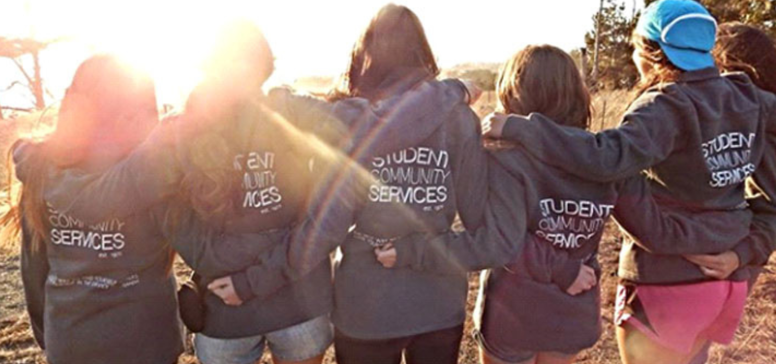 Student leaders pose in front of the sunset