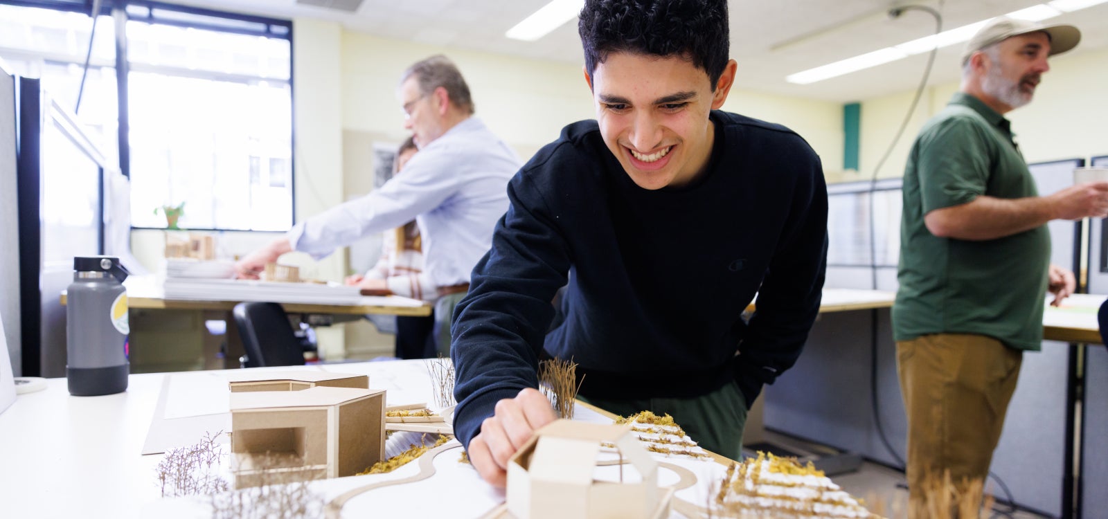 student working with a model design. 