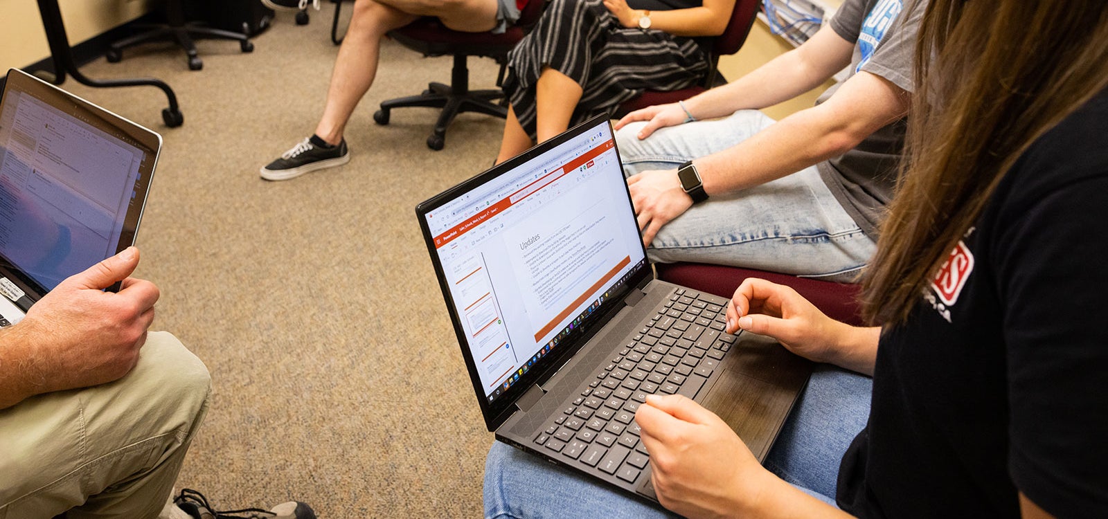 Student using a laptop on her lap