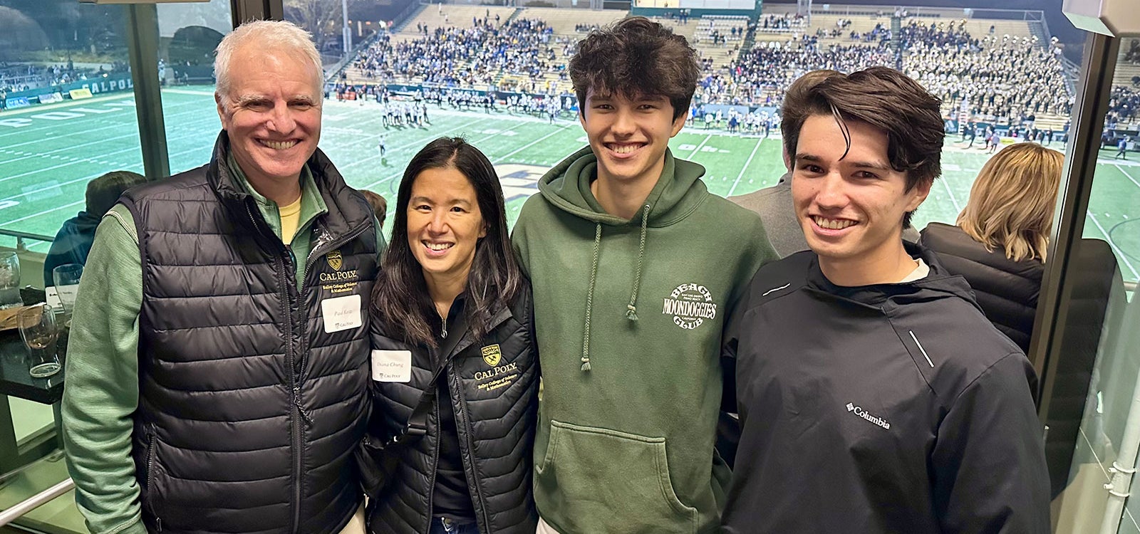 Paul Keitz and Diana Chung and sons attend Mustang Football game