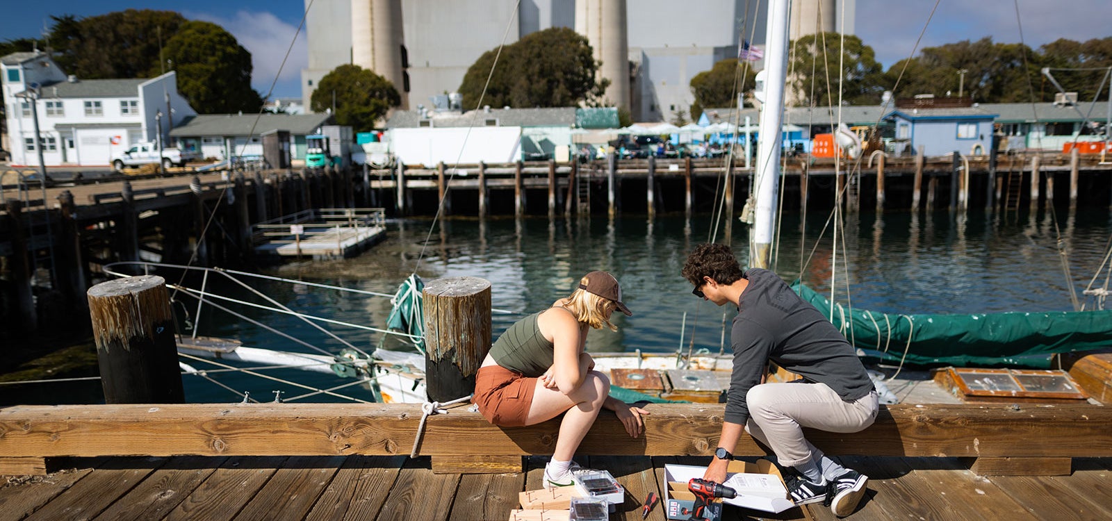 SURP engineering students deploy tide and wave gauges on one of the piers in Morro Bay.