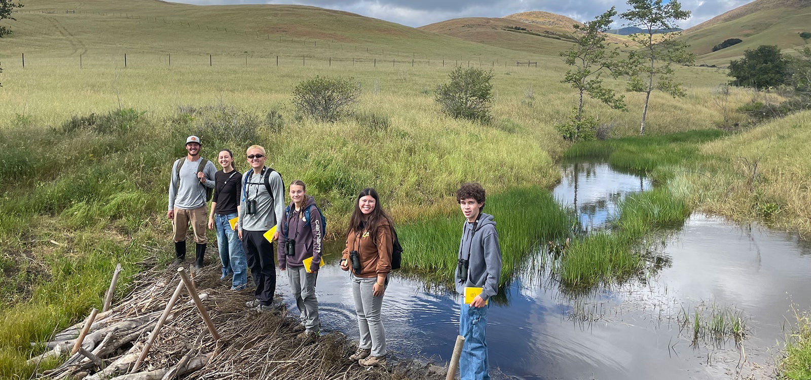 HARCS students conduct fieldwork near a creek