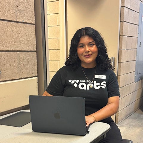 Angela Sanchez sitting with her laptop