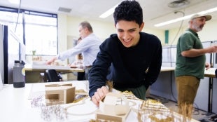 student working with a model design. 