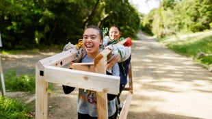 Student carrying structure to Design Village. 