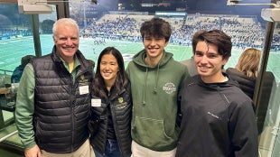 Paul Keitz and Diana Chung and sons attend Mustang Football game