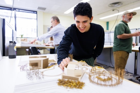 Student putting together a model city.