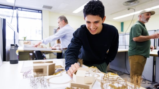 student working with a model design.