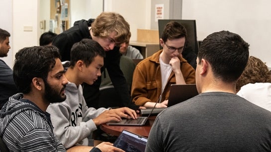 Students surrounding a computer.