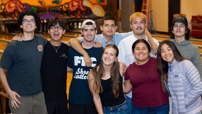 Group of diverse college students posing together at a social gathering
