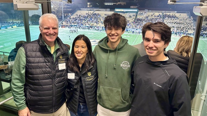 Paul Keitz and Diana Chung and sons attend Mustang Football game