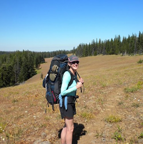 Kathleen Enz Finken on a hike with a backpack on