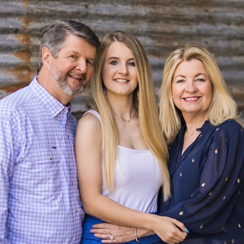 Robert Durham, daughter Anna Grace Durham, and Cheryl Durham pose with smiles