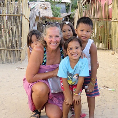 Cindy Shurtleff plays with local children in the Philippines in 2017. 