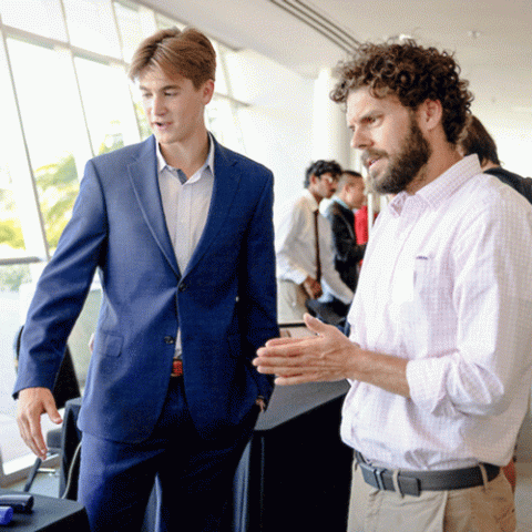 Professor Erik Sapper (right), CSM Innovation Initiative program faculty coordinator, meets with a student. 