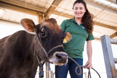 Student and cow, smiling for the camera