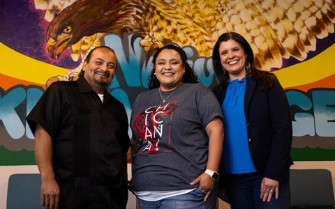 Professor Jenell Navarro and two others smiling for the camera