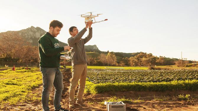 CAFES students in a field getting ready to fly a drone