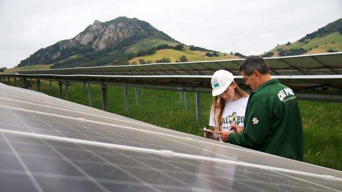 CENG Student with instructor working on solar panels