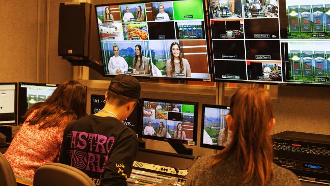 CLA broadcast media students in front of screens