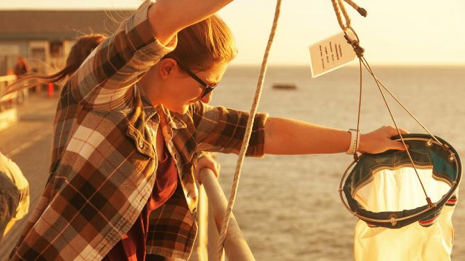 COSAM Student workin on a project in a boat on the ocean